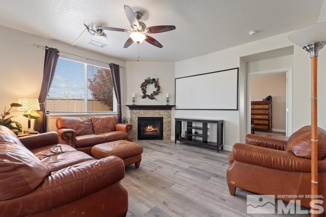 living room featuring light hardwood / wood-style flooring and ceiling fan