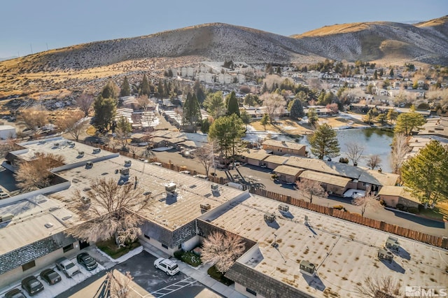 drone / aerial view featuring a water and mountain view