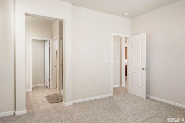 unfurnished bedroom featuring light colored carpet