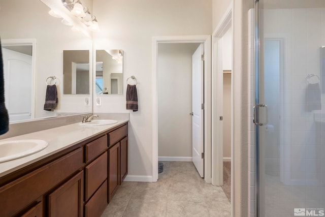 bathroom featuring tile patterned flooring, vanity, and walk in shower