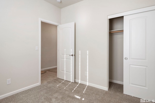 unfurnished bedroom with carpet floors and a closet