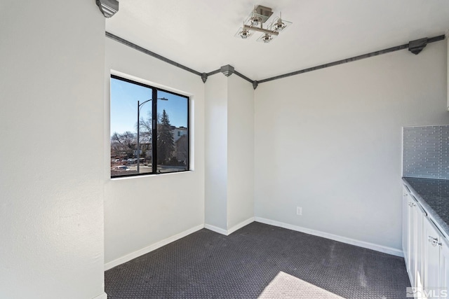 unfurnished dining area with crown molding