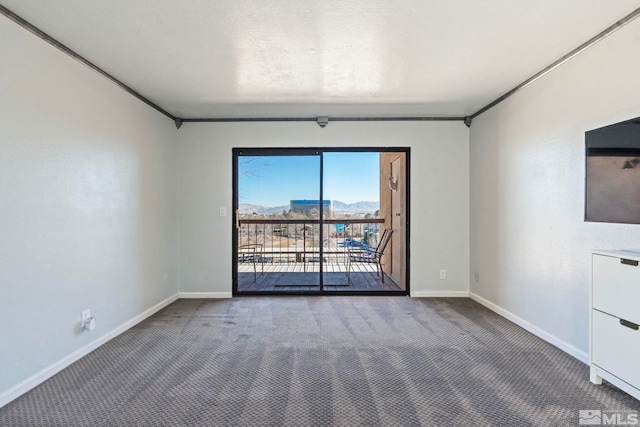 unfurnished room with crown molding and carpet floors