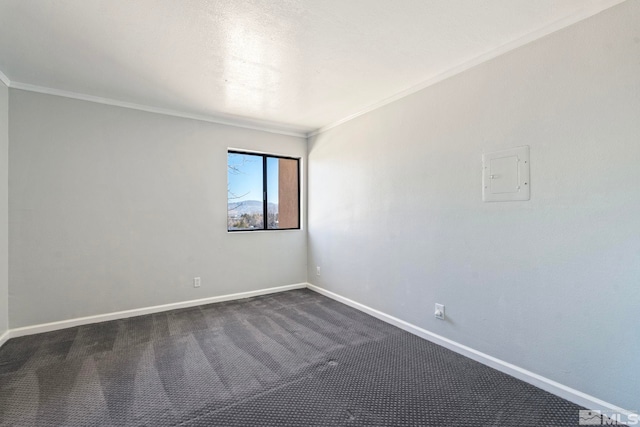 empty room featuring crown molding and dark colored carpet