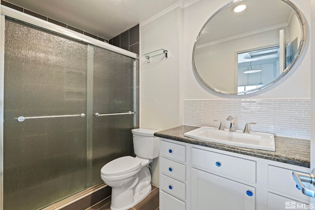 bathroom featuring tasteful backsplash, ornamental molding, vanity, and a shower with shower door