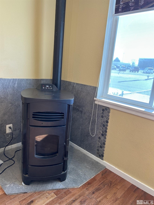 room details with hardwood / wood-style flooring and a wood stove