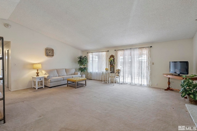 carpeted living room featuring vaulted ceiling and a textured ceiling