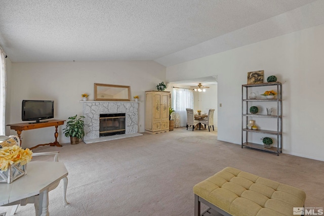 carpeted living room with a fireplace, vaulted ceiling, and a textured ceiling