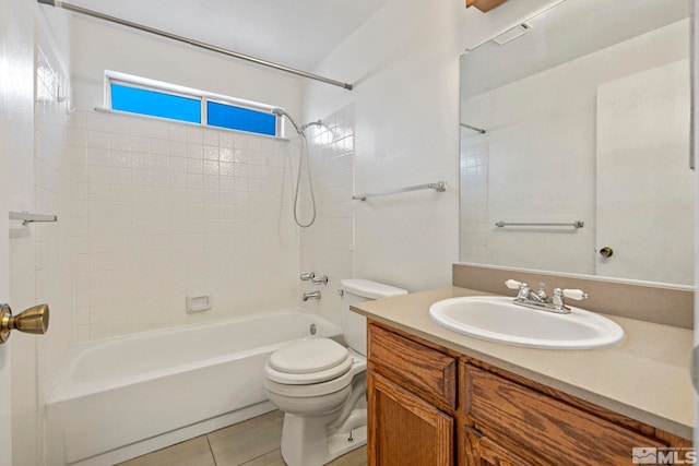 full bathroom with tile patterned flooring, tiled shower / bath, vanity, and toilet