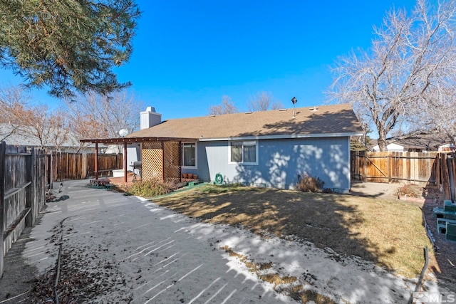 rear view of house with a lawn