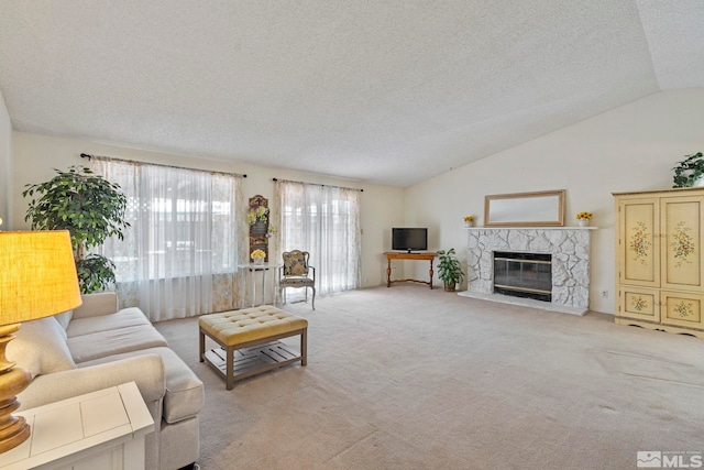 living room featuring lofted ceiling, a fireplace, light carpet, and a textured ceiling