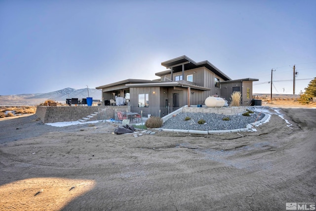 view of front of house with a mountain view and central AC unit