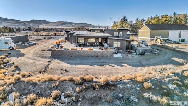 rear view of house featuring a patio and a mountain view