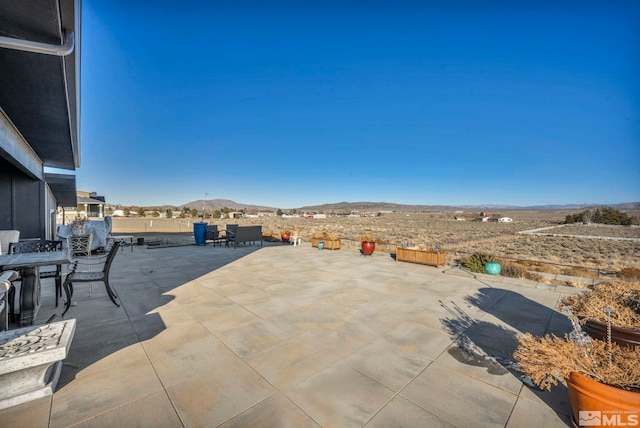 view of patio / terrace with a mountain view