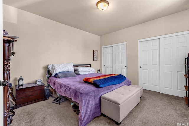 carpeted bedroom featuring two closets