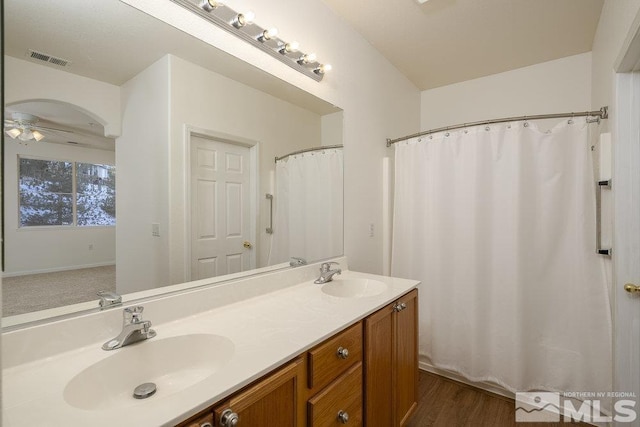 bathroom with ceiling fan, vanity, and wood-type flooring