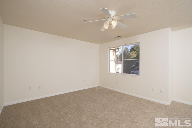 unfurnished room featuring visible vents, light carpet, and baseboards