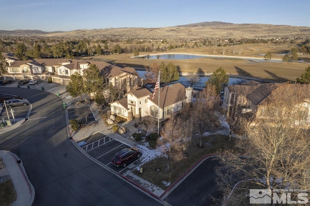 birds eye view of property with a residential view and a water and mountain view