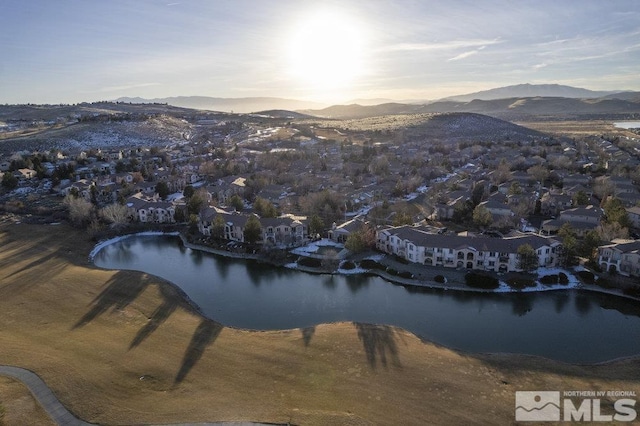 drone / aerial view featuring a water and mountain view