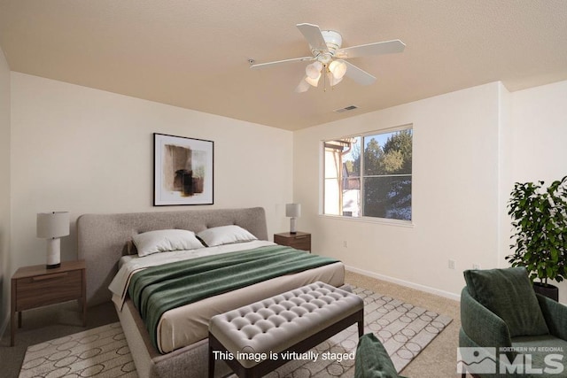 carpeted bedroom featuring visible vents, ceiling fan, and baseboards