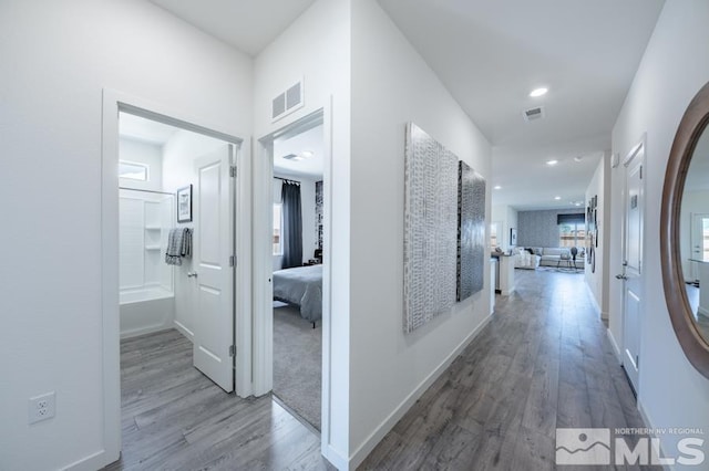 corridor with hardwood / wood-style flooring