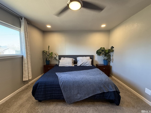 carpeted bedroom with ceiling fan and a textured ceiling