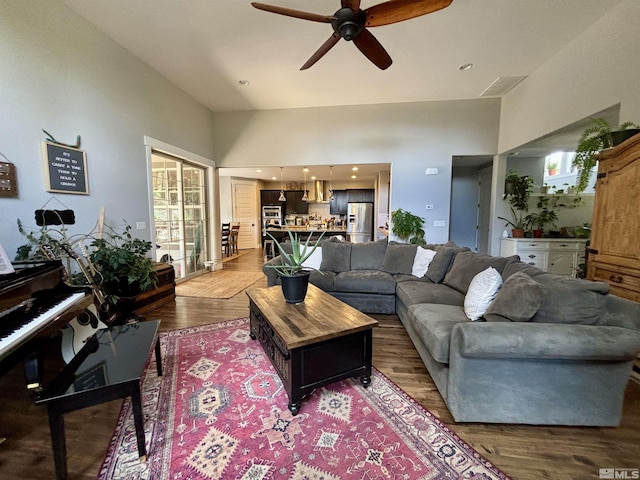 living room featuring wood-type flooring and ceiling fan