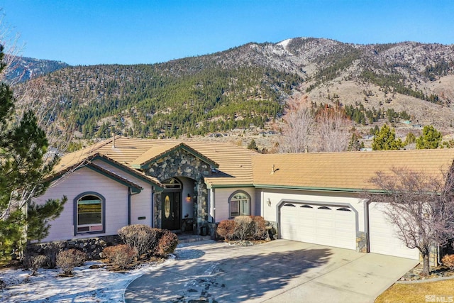 ranch-style home with a mountain view and a garage