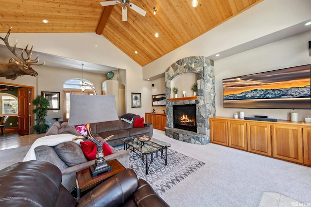 living room featuring ceiling fan, light carpet, a fireplace, and wood ceiling