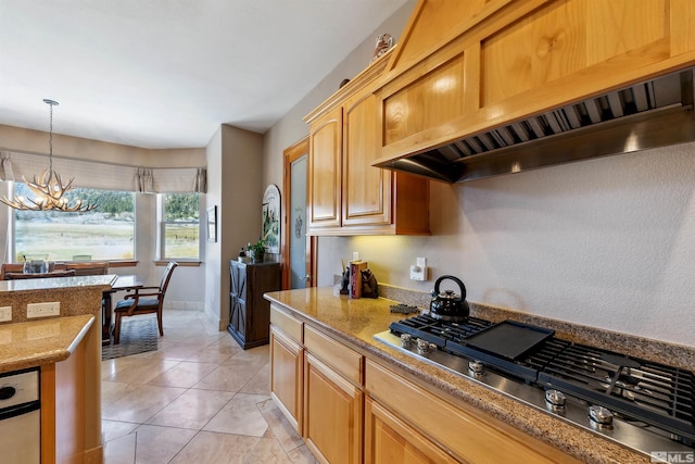 kitchen with stainless steel gas stovetop, a chandelier, custom exhaust hood, hanging light fixtures, and light tile patterned floors