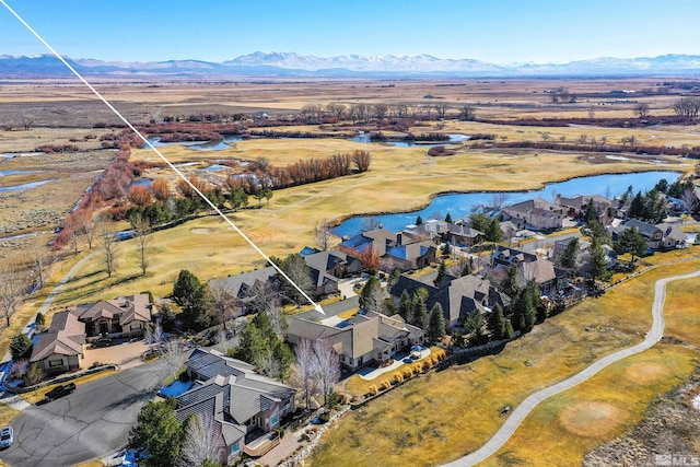 drone / aerial view with a water and mountain view