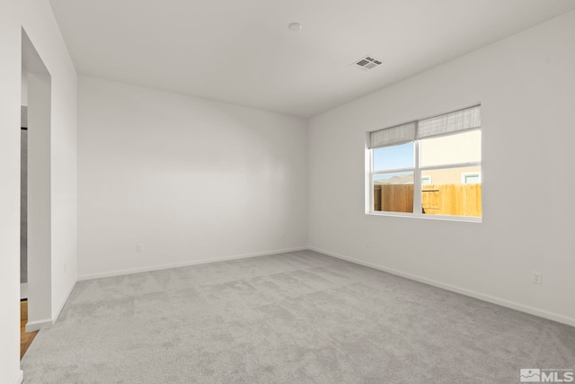 unfurnished room with light colored carpet