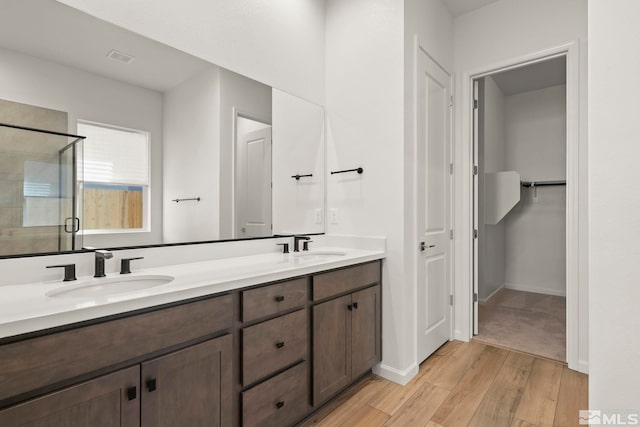 bathroom featuring vanity, hardwood / wood-style floors, and an enclosed shower