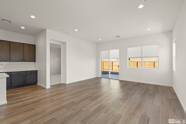 unfurnished living room with wood-type flooring