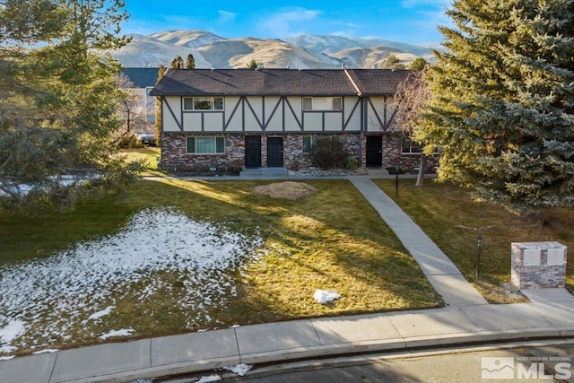 tudor house with a mountain view and a front yard