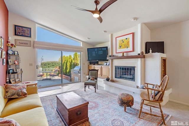 living room featuring lofted ceiling, light tile patterned floors, and ceiling fan