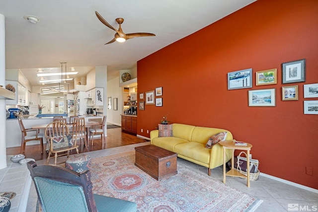 living room with light tile patterned floors and ceiling fan