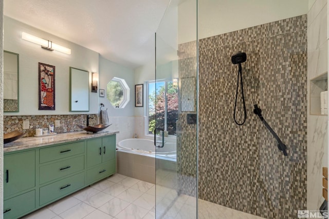 bathroom featuring vanity and separate shower and tub