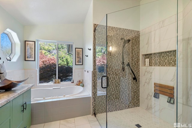 bathroom featuring shower with separate bathtub, vaulted ceiling, and vanity