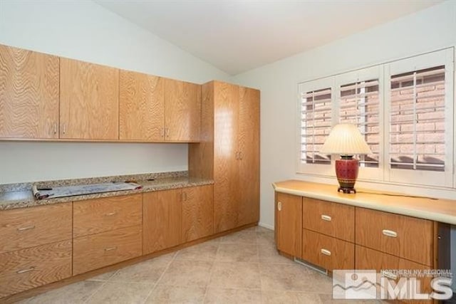 kitchen with vaulted ceiling and light tile patterned flooring