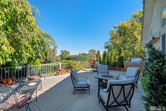 view of patio / terrace with area for grilling and an outdoor fire pit