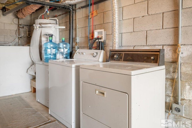 clothes washing area with separate washer and dryer