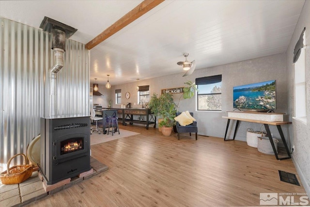 living room featuring hardwood / wood-style floors, beam ceiling, and sink