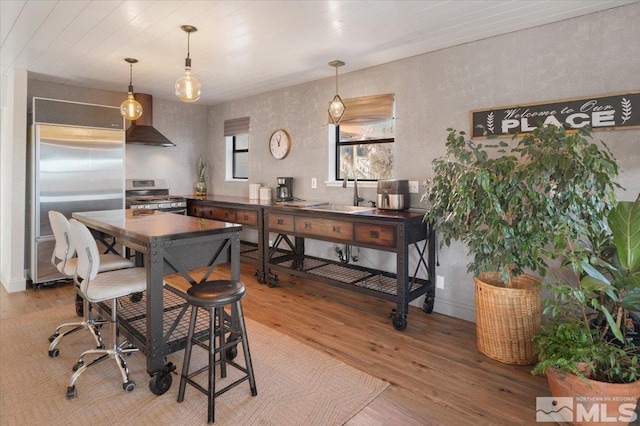 dining space featuring hardwood / wood-style floors and sink