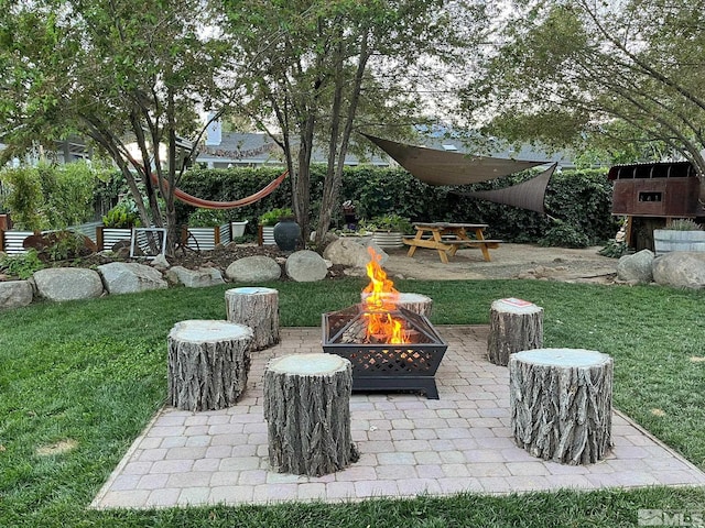 view of yard featuring a fire pit and a patio area