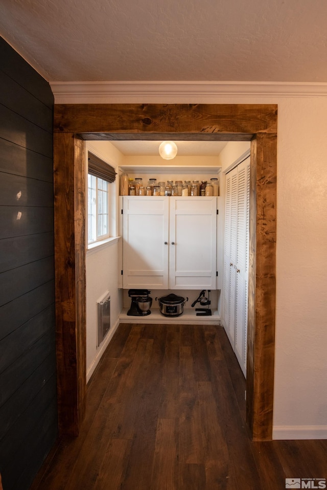 mudroom with crown molding and dark hardwood / wood-style flooring