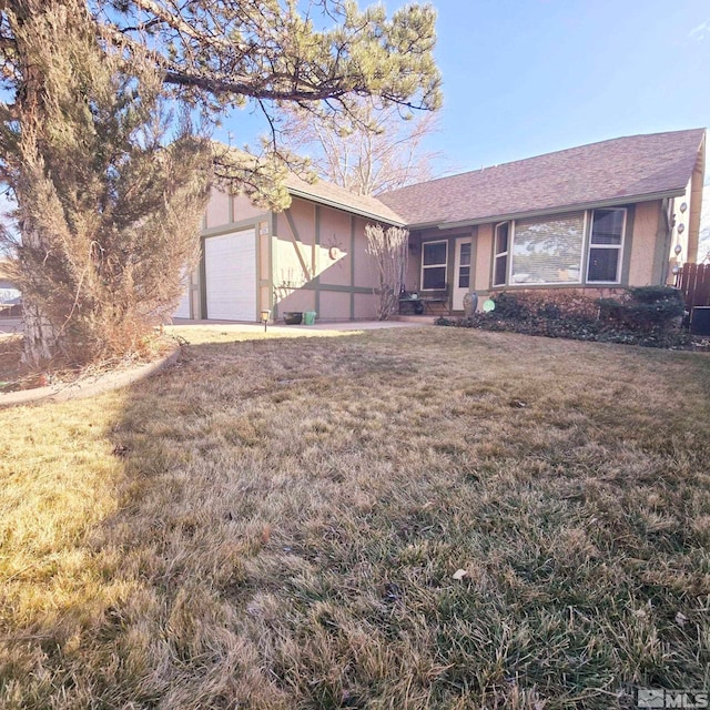 view of front of house with a garage and a front yard