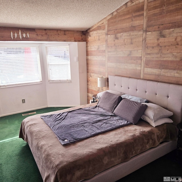 carpeted bedroom featuring vaulted ceiling, a textured ceiling, and wood walls