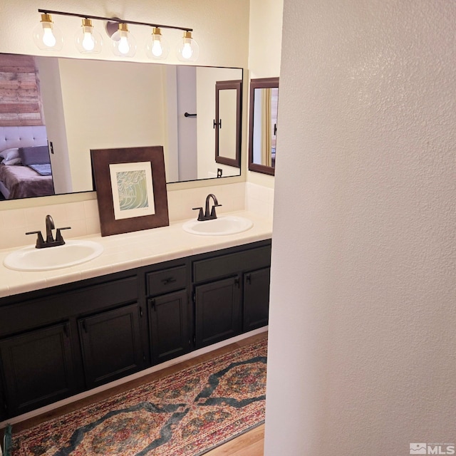 bathroom featuring vanity and decorative backsplash