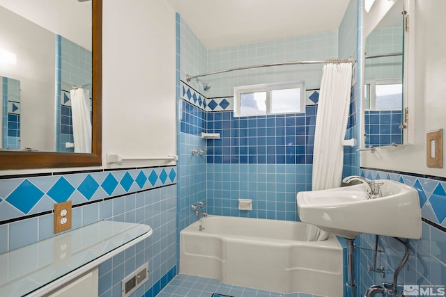 bathroom featuring tile patterned flooring, tile walls, and shower / bath combo